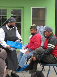 Sister helping men with new shoes