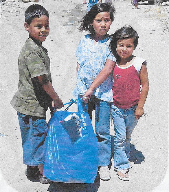 3 kids with a bag